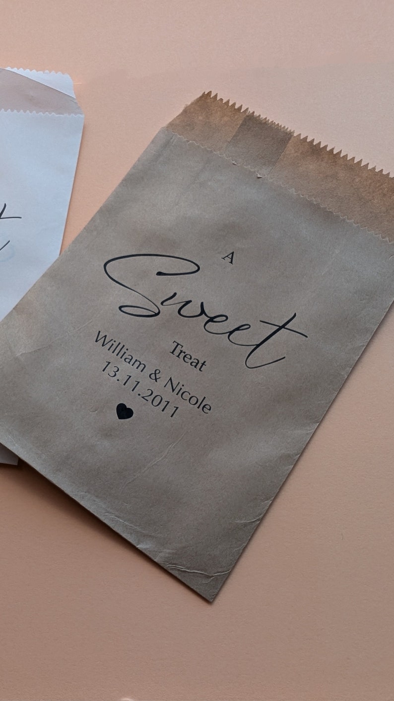 May include: A brown paper bag with the text "A Sweet Treat William & Nicole 13.11.2011" and a small heart.
