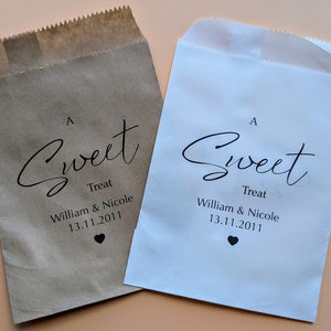 May include: Two paper bags with an "A Sweet Treat" design. The bags are brown and white and have the text "William & Nicole 13.11.2011" printed on them.