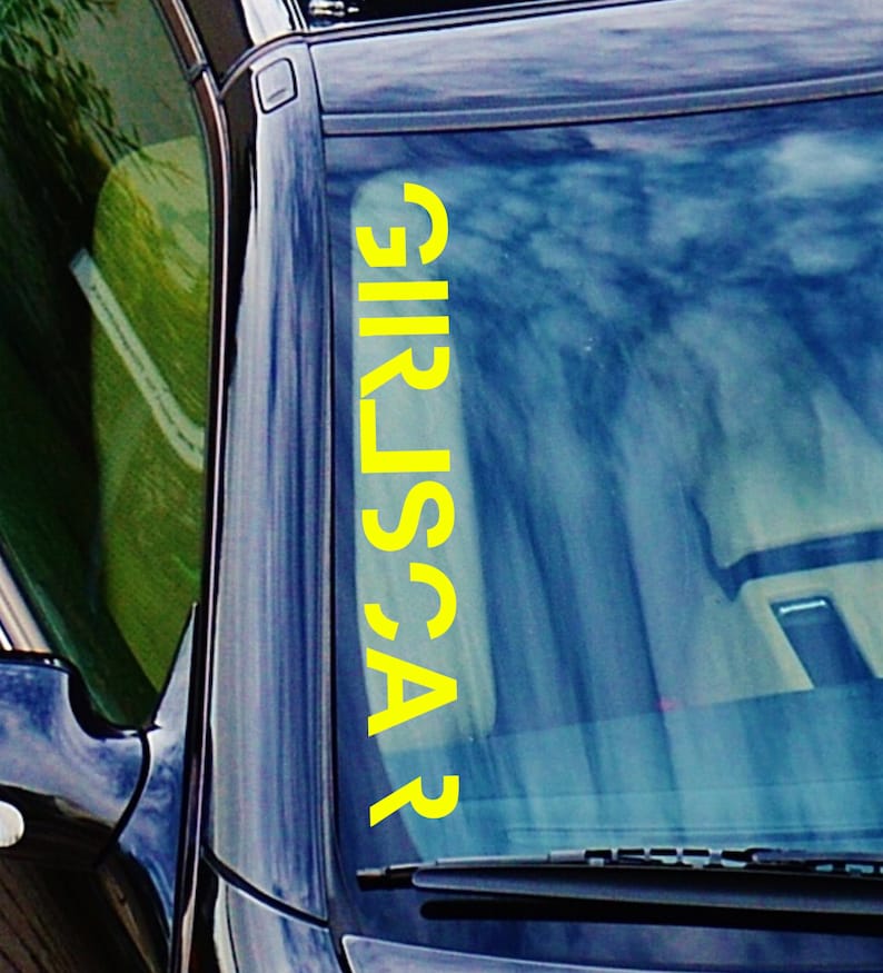 May include: A yellow vinyl decal with the word "CARS" written vertically on a car windshield.