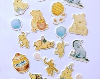 May include: A collection of die-cut stickers featuring Winnie the Pooh characters including Pooh, Piglet, Tigger, and Eeyore. The illustrations show various scenes with honey pots labeled Hunny, balloons, party hats, and gifts in soft watercolor tones.