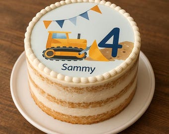 May include: A round cake with a white frosting border and a decorative top featuring a yellow bulldozer, blue number 4, and the name "Sammy". The cake sits on a white plate against a wooden background.