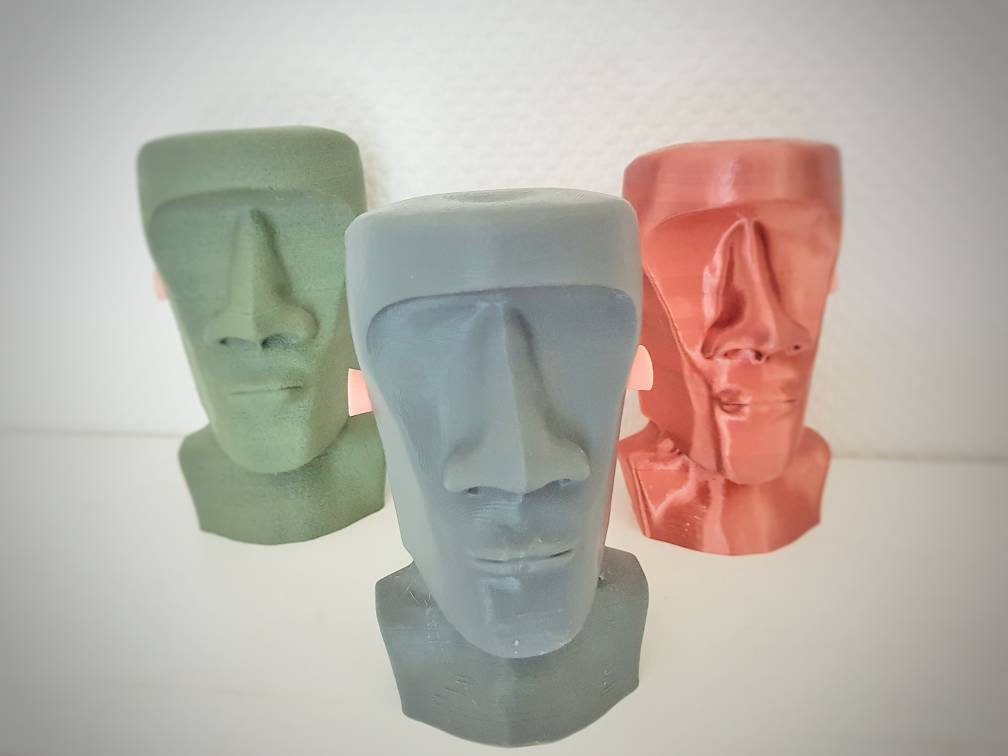 Humorous moai sculpture with pilot helmet