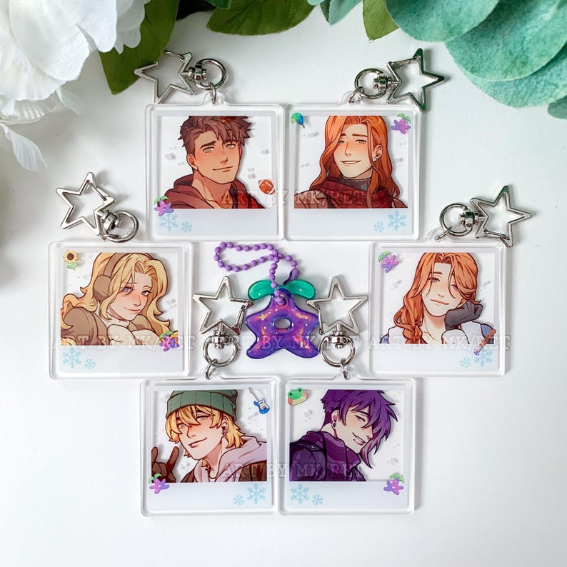 May include: Collection of clear acrylic keychains featuring anime-style character portraits. Each keychain has a silver star-shaped charm and a silver keyring. The portraits depict various characters with different hairstyles and clothing.