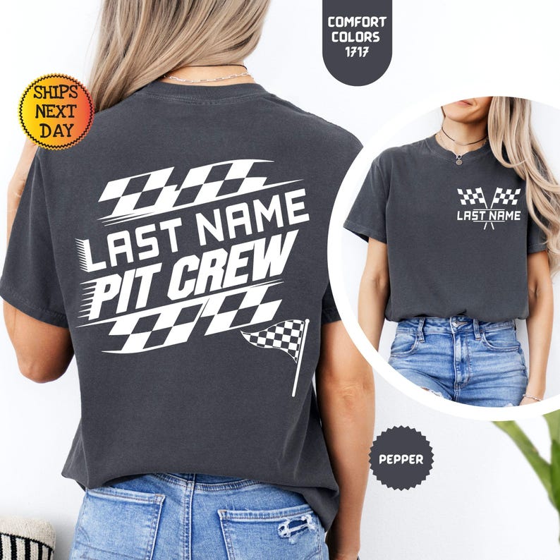 May include: A dark gray t-shirt with a white design on the back that says "Last Name Pit Crew" with a checkered flag design. The front of the shirt has a smaller checkered flag design with the text "Last Name".