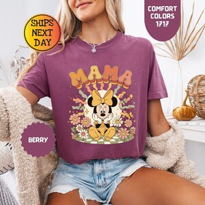 May include: A white ceramic mug with a black handle and the text "But First, Coffee" in a black, bold font. The mug is on a white surface. The mug is approximately 4 inches tall.