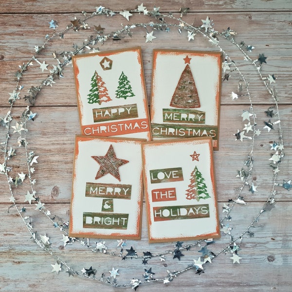 Set of 4 handmade Christmas cards. Hand painted with copper highlights & jute embellishments and die cut decorations and sentiments.