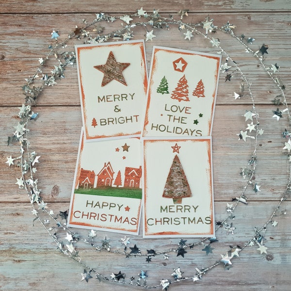 Pack of 4 handmade Christmas cards. Hand painted with copper highlights & jute embellishments and die cut decorations and sentiments.