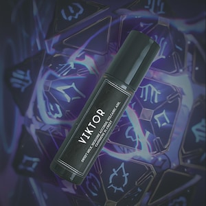 May include: A black roll-on perfume bottle with a label that reads "VIKTOR". The label also lists the scent notes: Sweet Milk, Hexcore Accords, Volcanic Ash, and Cashmere Blanket. The background features a blurred, geometric design in shades of purple and blue.