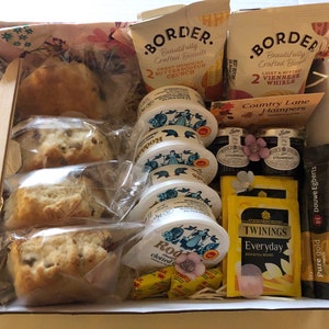 Afternoon tea hamper. English tea, scones, clotted cream, jam and biscuits.