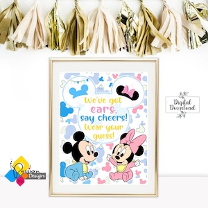 May include: A printable sign with a blue and white background featuring Mickey and Minnie Mouse dressed in baby clothes. The text on the sign reads "We've got ears, say cheers! Wear your guess!"