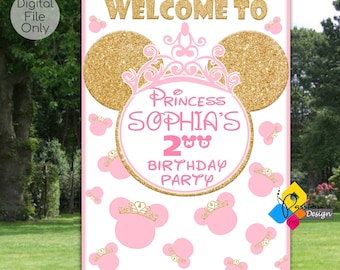 Puede incluir: Un cartel de bienvenida rosa y dorado para una fiesta de cumpleaños con temática de princesa. El cartel presenta una gran oreja de Mickey Mouse de purpurina dorada con una corona rosa y el texto "Bienvenido a la fiesta de cumpleaños de la princesa Sofía de 2 años".