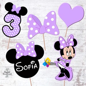 May include: Purple and black Minnie Mouse themed party decorations with a number 3, a bow, a heart, and a Minnie Mouse head with the name Sofia.