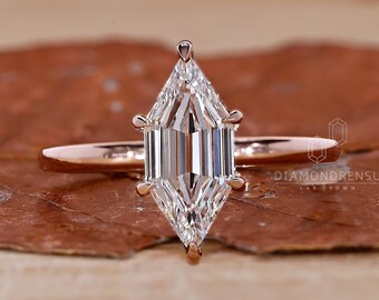 May include: A rose gold engagement ring with a large, clear, emerald-cut diamond. The ring is set on a thin band and is sitting on a brown, textured surface. The text "DIAMONDRENSU LAB GROWN" is visible in the lower right corner of the image.
