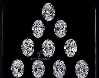 May include: Ten oval-shaped diamonds arranged in a triangular pattern on a black background. The diamonds are all clear and sparkly.