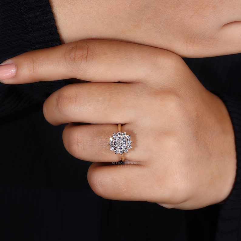 Hand gracefully displaying the lab grown diamond ring in yellow gold by Diamondrensu