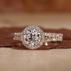 Graceful hand displaying Round Diamond Halo Ring with elegant Split Shank Band design.