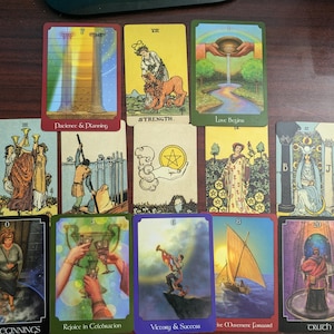 May include: A tarot card spread with ten cards, each featuring a different image and text. The cards are arranged in a row, with the first card on the left and the last card on the right. The cards are all in a similar style, with a colorful background and a central image. The text on the cards is in a black font and is easy to read. The cards are all in good condition and are ready to be used for a tarot reading.