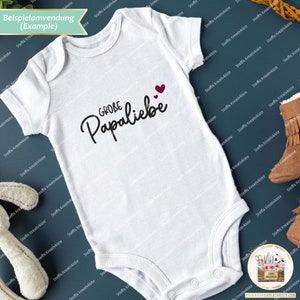 May include: White baby onesie with black text that reads "GROBE Papaliebe" with two small red hearts above the text.