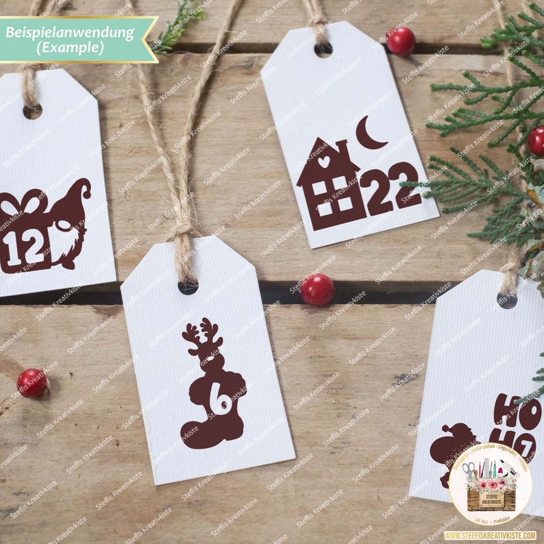 May include: Four white gift tags with brown ink designs. The tags feature a reindeer, a house with a crescent moon, a gnome, and the words "Ho Ho Ho". The tags are tied with twine and are on a wooden surface.