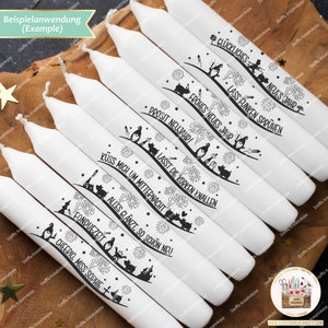 May include: Ten white candles with black ink designs and German text. The text on the candles includes "Gl&uuml;ckliches Neues Jahr", "Lass Funken Spr&uuml;hen", "Frohes Neues Jahr", "Prosit Neujahr", "Lasst die Korken Knallen", "K&uuml;ss mich um Mitternacht", "Alles gl&auml;nzt, so sch&ouml;n neu", "Fonduezeit", and "Cheerio, Miss Sophie".