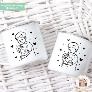 May include: Two white enamel mugs with black outlines of a father and child hugging. The mugs have black hearts scattered around the image. The text "Beispielanwendung (Example)" is at the top of the image.