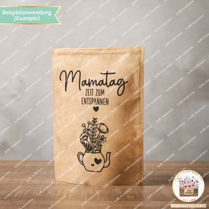 May include: A brown paper bag with a black and white illustration of a teapot with flowers and the text "Mamatag Zeit zum Entspannen" (Mother's Day Time to Relax).