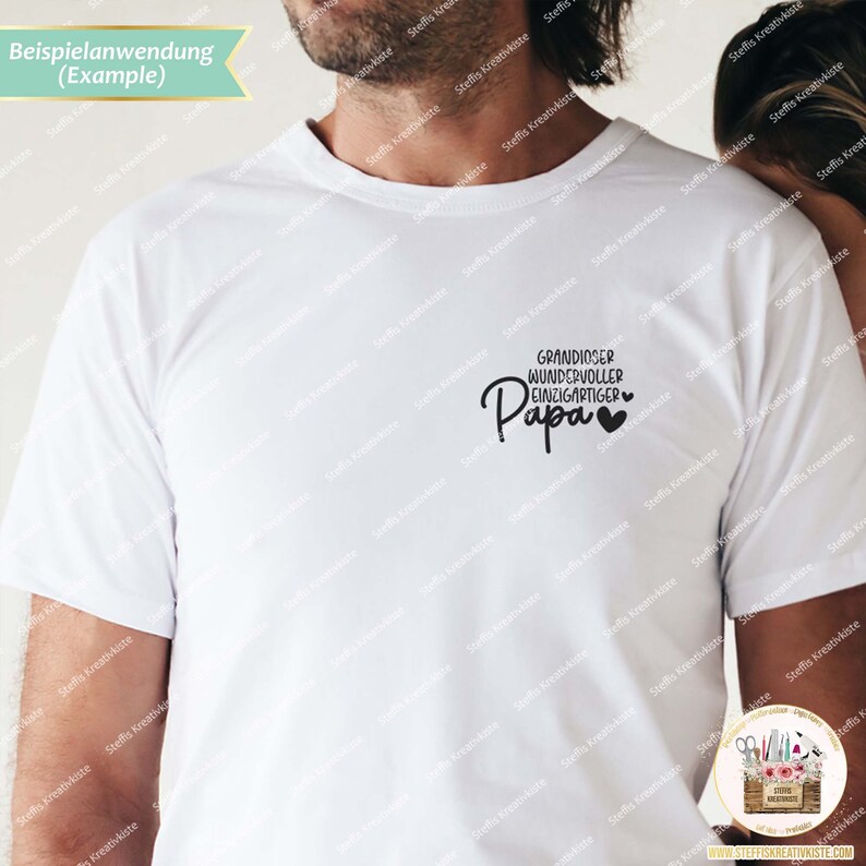 May include: White t-shirt with black text that reads "Grandiose Wonderful Unique Papa" with two small hearts.