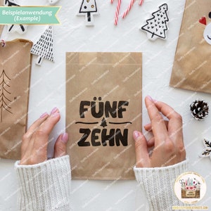 May include: A brown paper bag with the words "F&Uuml;NF ZEHN" printed in black. The bag is being held by a person's hands.