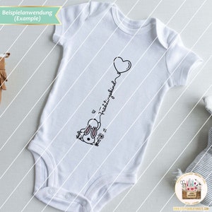May include: White baby onesie with a black and white illustration of a bunny holding a pink heart balloon. The text "&  fr&uuml;hlingskind" is written on the onesie.