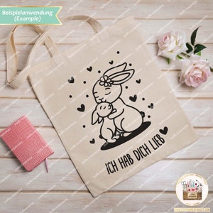 May include: A white tote bag with black bunny illustrations and the text "ICH HAB DICH LIEB". The bunnies are hugging and have hearts around them.