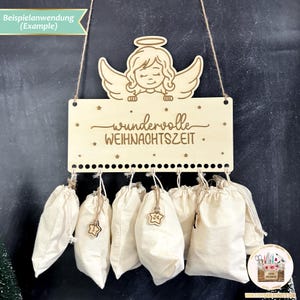 May include: A wooden Christmas advent calendar with a hanging angel and the text "wundervolle WEIHNACHTSZEIT". The calendar has 24 small fabric bags hanging from it.