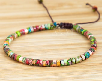 May include: A colorful beaded bracelet with a brown cord closure. The beads are small and round, with a variety of colors and patterns. The bracelet is adjustable.
