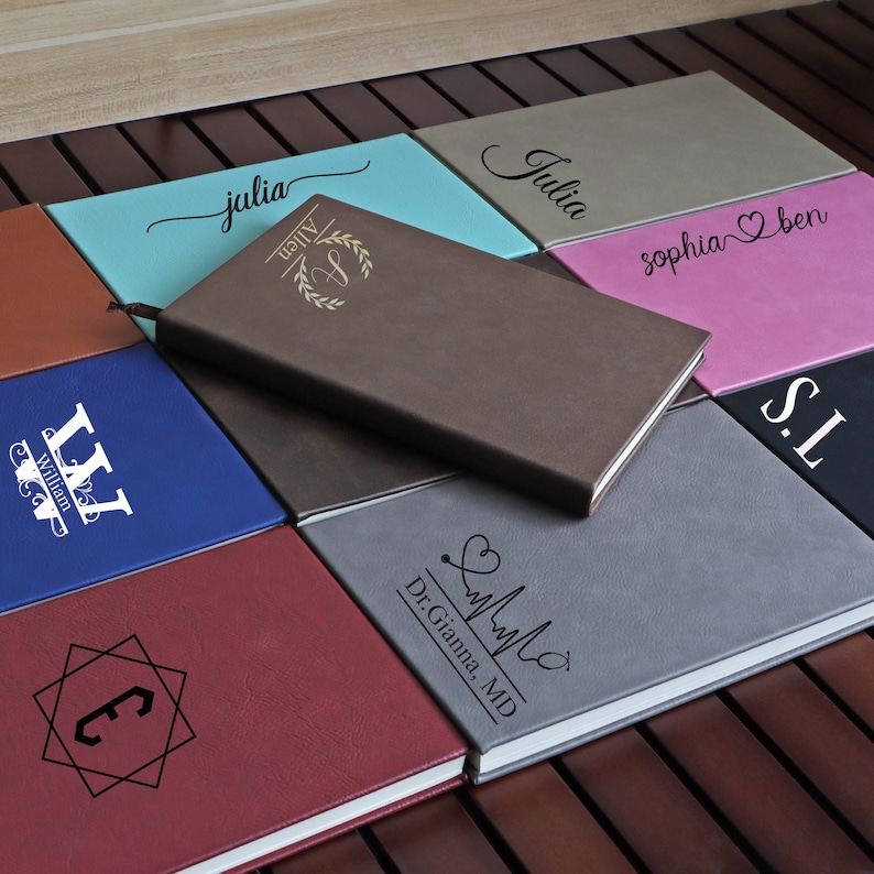 May include: A collection of personalized leather journals with various designs and names, including "Julia", "Sophia & Ben", "WW", "C", "Dr. Gianna, MD", "S.I", and "Allen".