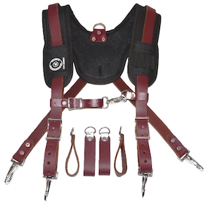 May include: A set of brown leather tool suspenders with a black mesh back panel, four metal clips, and three leather loops with metal rings.