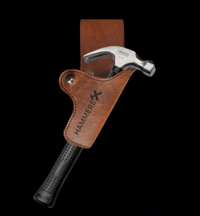May include: A brown leather hammer holster with the word "HAMMERE" engraved on it. A silver hammer with a black rubber handle is in the holster.