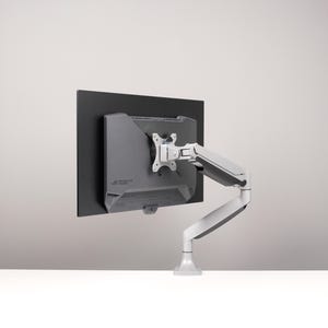 May include: A computer monitor mounted on a white and gray adjustable arm. The monitor is black, and the arm has multiple joints for flexible positioning. The base is white, and the arm is attached to the back of the monitor.