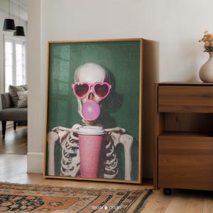 May include: A skeleton wearing pink heart-shaped sunglasses and blowing a bubble of pink bubble gum, holding a pink to-go coffee cup.