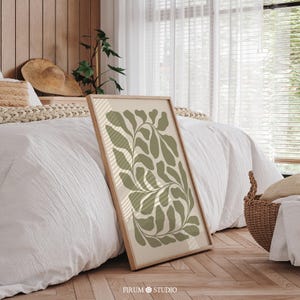 This Abstract Botanical Leaves Printable Art features a calming blend of sage green and beige tones, evoking the natural beauty of Mediterranean landscapes. The organic, flowing shapes and minimalist design make it an ideal addition to modern boho or Japandi-inspired decor. Perfect for your living room, bedroom, or any space in need of a nature-inspired, serene atmosphere.