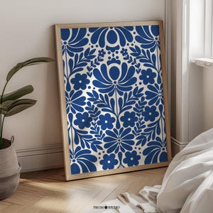 May include: A framed print with a blue and white floral pattern. The pattern features stylized flowers and leaves in a repeating design.