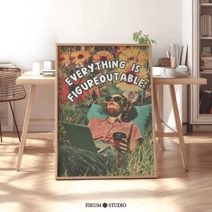 May include: A framed art print with a vintage aesthetic. It depicts a woman in sunglasses relaxing in grass with a laptop and coffee. The print features the text "EVERYTHING IS FIGUREOUTABLE" against a backdrop of colorful flowers.