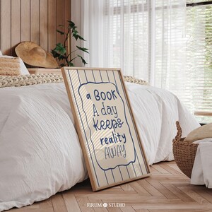 Whimsical hand-drawn wall art featuring the quote “A Book A Day Keeps Reality Away” in playful navy-blue lettering on a cream background with vertical wavy stripes and a doodled frame. This charming printable is perfect for book lovers, cozy reading nooks, or eclectic dorm decor. A delightful mix of humour and escapism, ideal for adding personality to your digital download art collection or gifting to fellow bibliophiles.