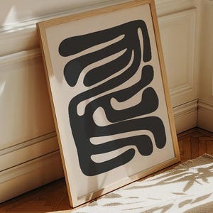 Beige and black abstract mid-century modern wall art featuring organic geometric shapes. This printable artwork blends minimalist aesthetics with neutral tones, perfect for contemporary living rooms, bedrooms, and offices. Available as a high-resolution digital download for instant printing