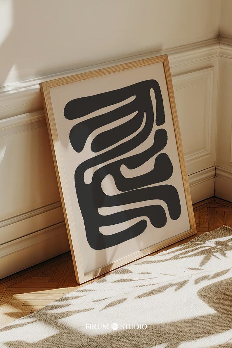 Beige and black abstract mid-century modern wall art featuring organic geometric shapes. This printable artwork blends minimalist aesthetics with neutral tones, perfect for contemporary living rooms, bedrooms, and offices. Available as a high-resolution digital download for instant printing