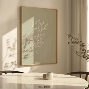 Sage green minimal botanical printable wall art featuring elegant floral line drawings in a muted green palette. This digital artwork blends minimalist aesthetics with modern decor, perfect for stylish apartments, living rooms, and gallery walls. Available as a high-resolution digital download for instant printing