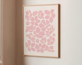 May include: A framed wall art print featuring a repeating pattern of stylized pink flowers with yellow dotted centers on a cream background. The rectangular frame is made of light-colored wood. The text FIRUM STUDIO is printed at the bottom.