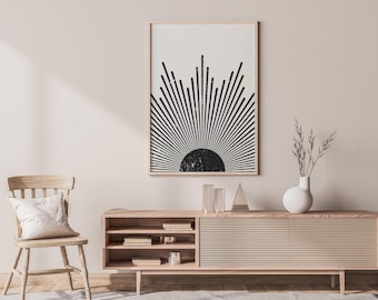 May include: A rectangular wall art print featuring a black sun graphic with radiating lines on a white background, displayed in a light wood frame. The artwork depicts a stylized sunburst design with a textured, distressed black semi-circle base.