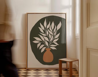 Puede incluir: Una impresión de arte mural rectangular enmarcada que presenta una forma circular de color verde oliva oscuro que contiene una ilustración botánica blanca de hojas en un jarrón de color terracota. El texto FIRUM STUDIO está impreso en blanco.