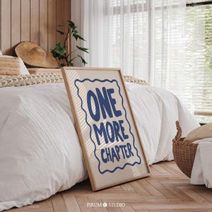 Minimalist book lover quote wall art featuring the phrase “One More Chapter” in bold, playful navy-blue lettering inside a hand-drawn squiggly border on a soft cream background. Perfect for cozy reading corners, modern bedrooms, or literary-themed dorm decor. This downloadable art print is ideal for bibliophiles and readers who just can’t put the book down. A quirky and stylish digital artwork for instant download.