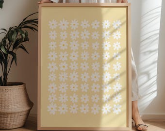 May include: A rectangular framed wall art piece featuring a repeating grid pattern of white daisy flowers with yellow centers on a solid light yellow background. The frame is made of light-colored wood. The text FIRUM STUDIO is printed at the bottom.