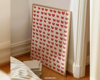 May include: A framed print with a pattern of red hearts on a white background. The frame is made of wood and has a light brown finish.